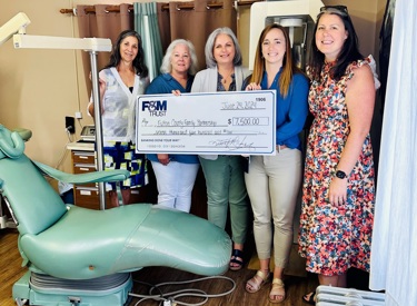 Executive Program Director Ellen Ott and Executive Development Director Julie Dovey of Fulton County Family Partnership and Volunteer Dental Clinic Coordinator Patricia Rhodes recently accepted a check from F&M Trust Community Office Manager Mary Kate Mumper and Regional Market Manager Meghan Heebner.